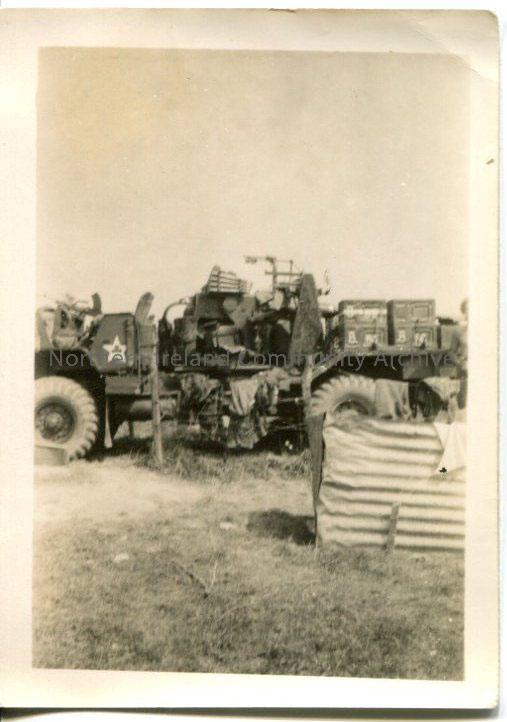Black and white photograph of a military vehicle in a field