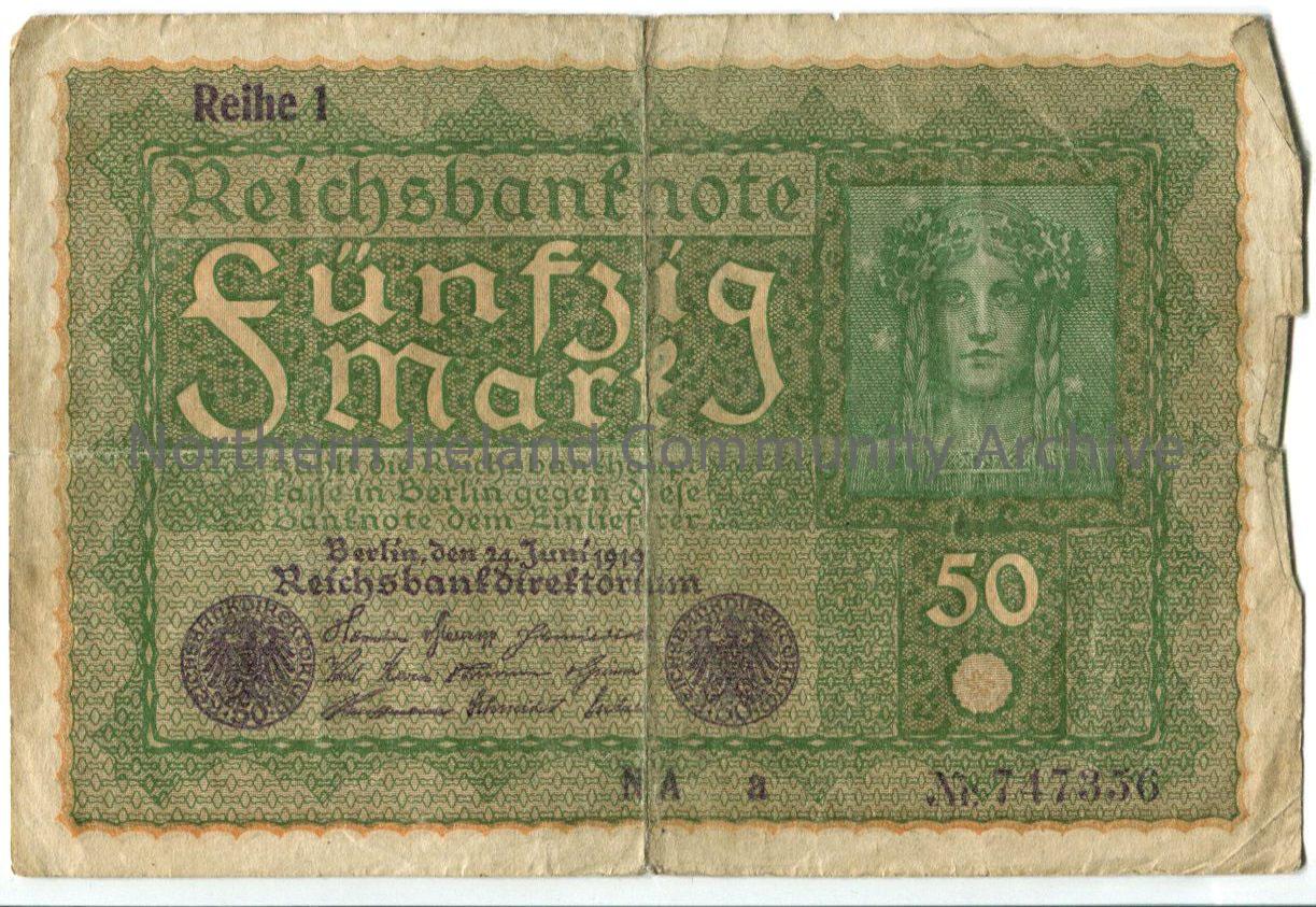 50 Mark Banknote. One side is green with Funfzig Mark and an image of a woman with flowers in her hair and pig tails. The other side is blue/brown wit…