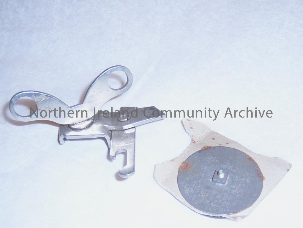 small metal can opener with circular metal disc, perhaps once part of it (from the donors mothers 1950s kitchen) (1695)