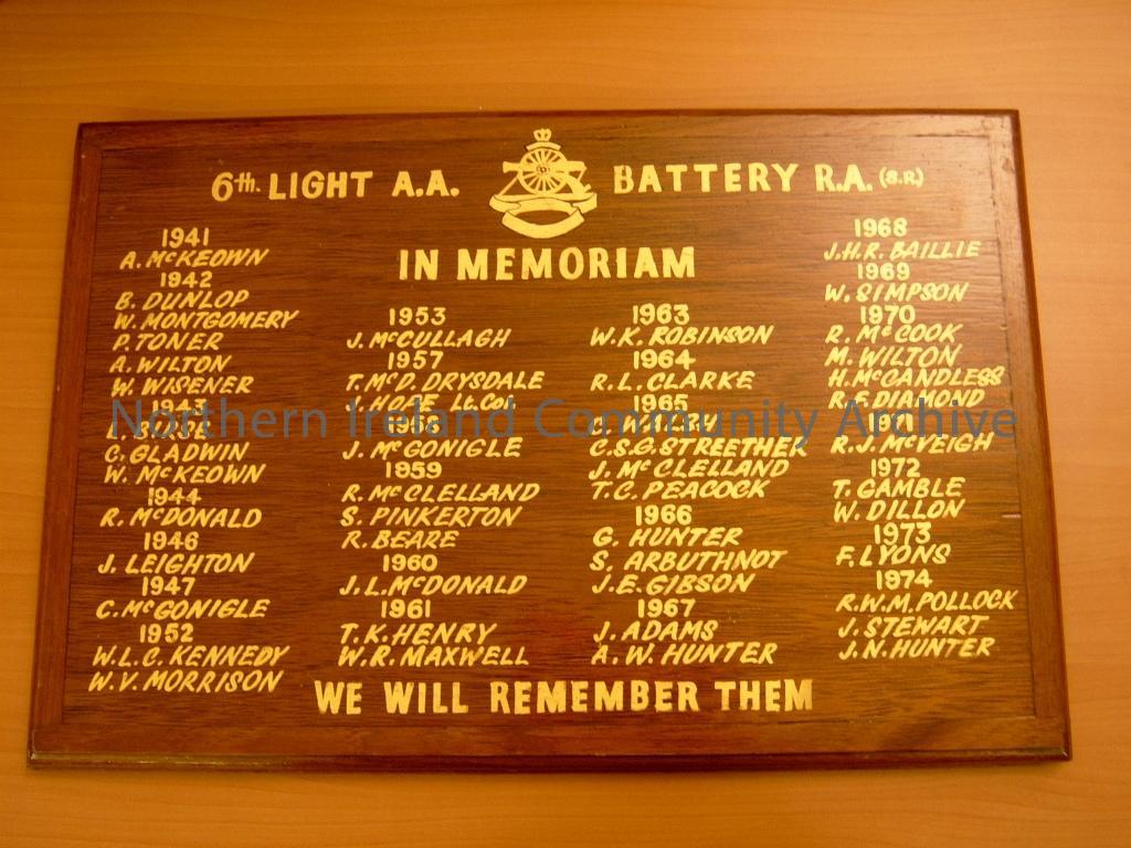 in memoriam wooden board with stand attached on back. For the 6th Light A A Coleraine battery RA (SR). We Will Remember Them, it records the names of the veterans that served and the years they died from 1941- 1974 in gilt (1981)