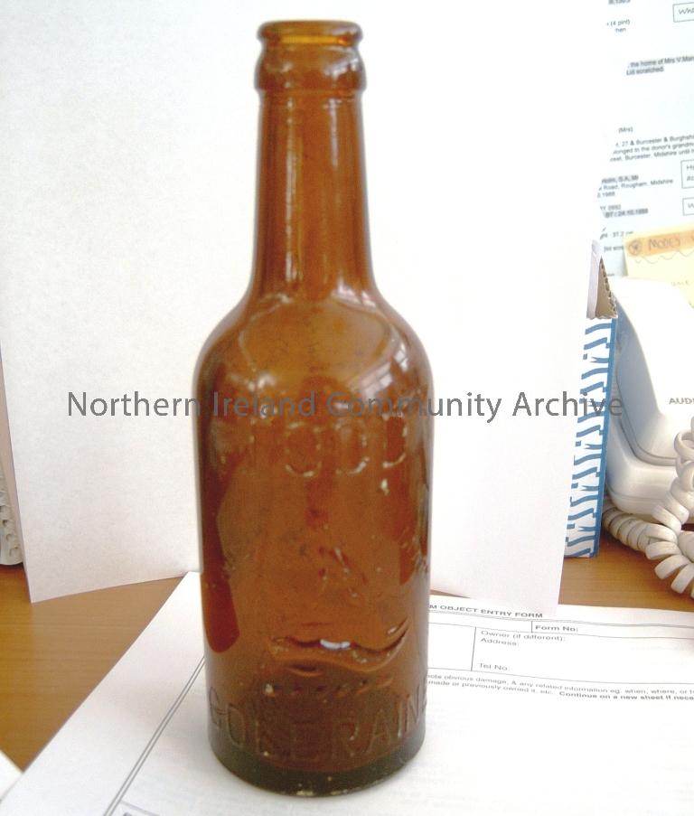 brown glass bottle, marked Todd Coleraine with a trade mark of a dog sitting on a plinth possibly with water below (2905)