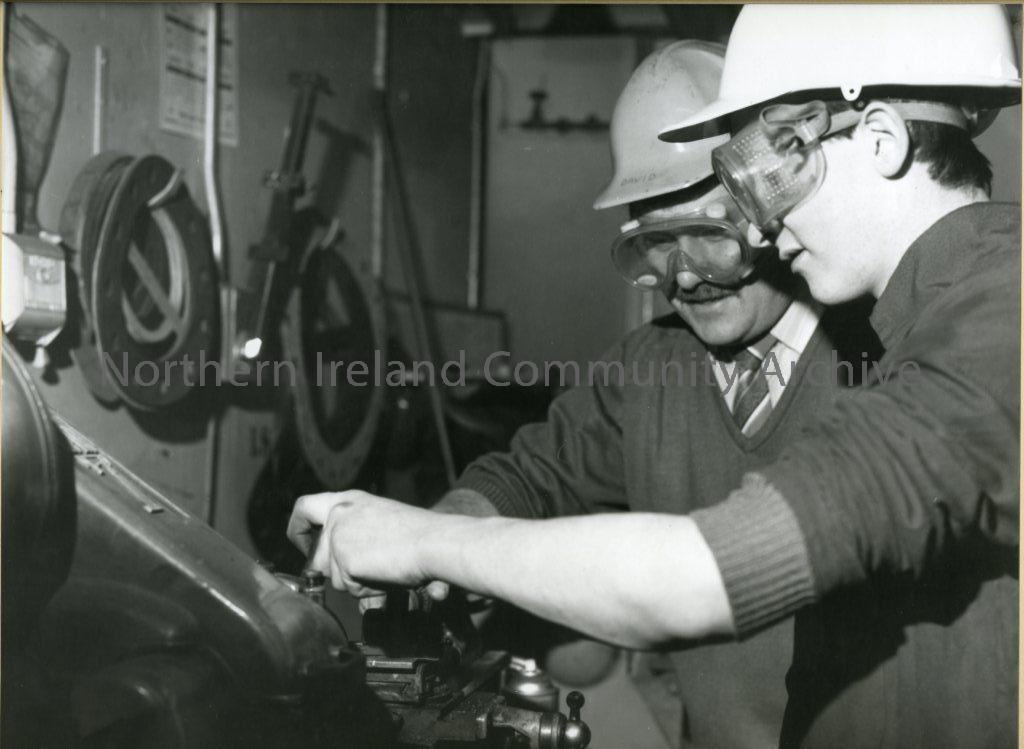 black and white photograph of 2 men in a possible control room (6502)