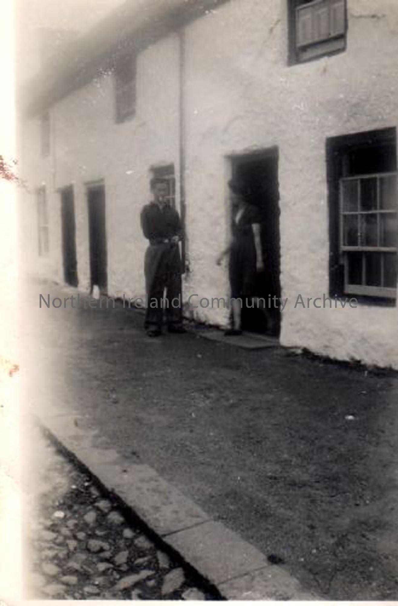 Nan McLernon (Annie) talking to her nephew James Johnston at her own front door on the Main Street. Note James Johnston lost his arm in the new mill Knowe Head Street owned by McAlisters. (4092)