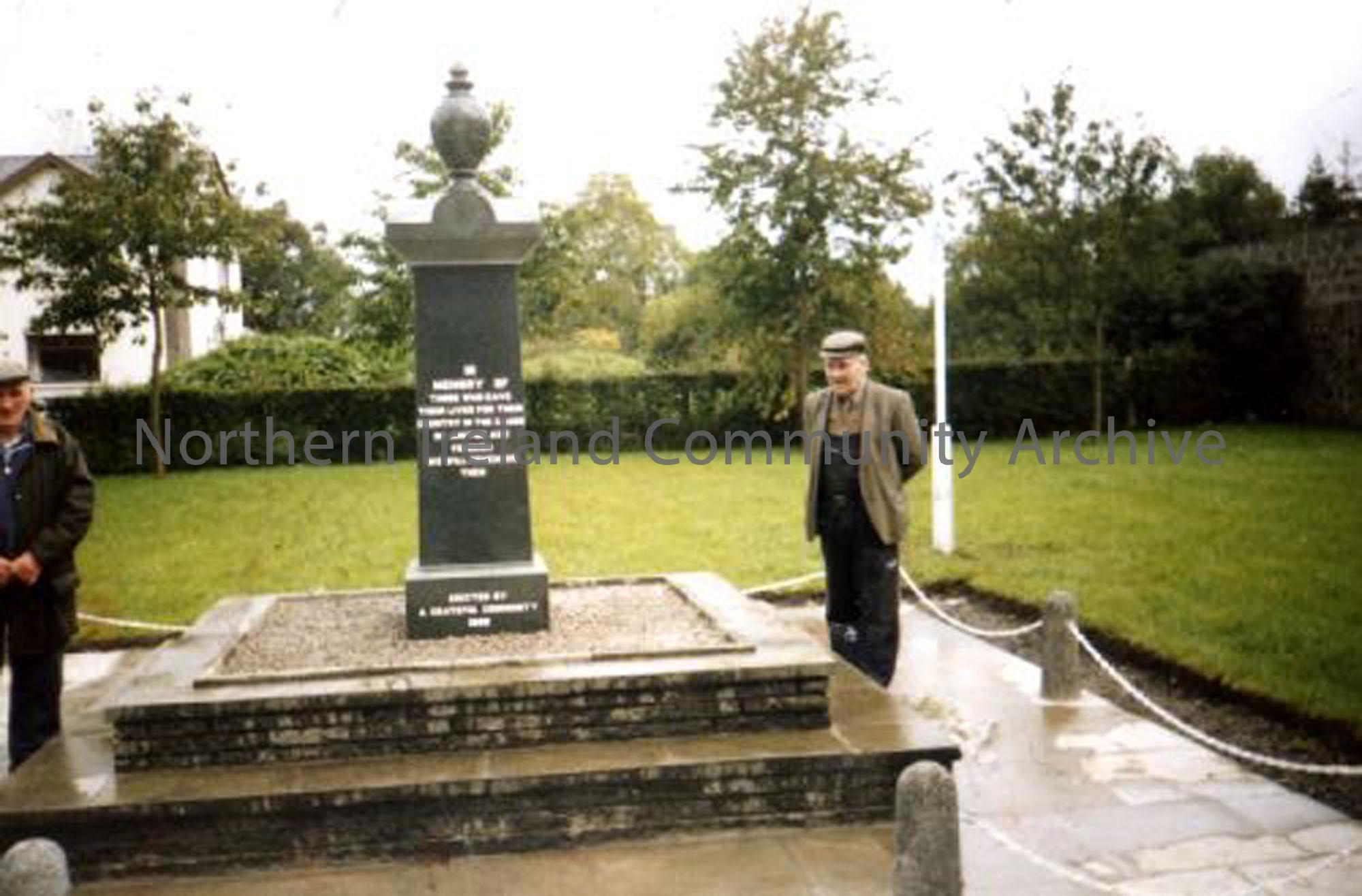 Hugh McCaughan at the new War Memorial, which was put up thanks to the British Legion. Brass plaques with the names of all those from Dervock who served in the two World Wars was later added in panels at the back. (5209)