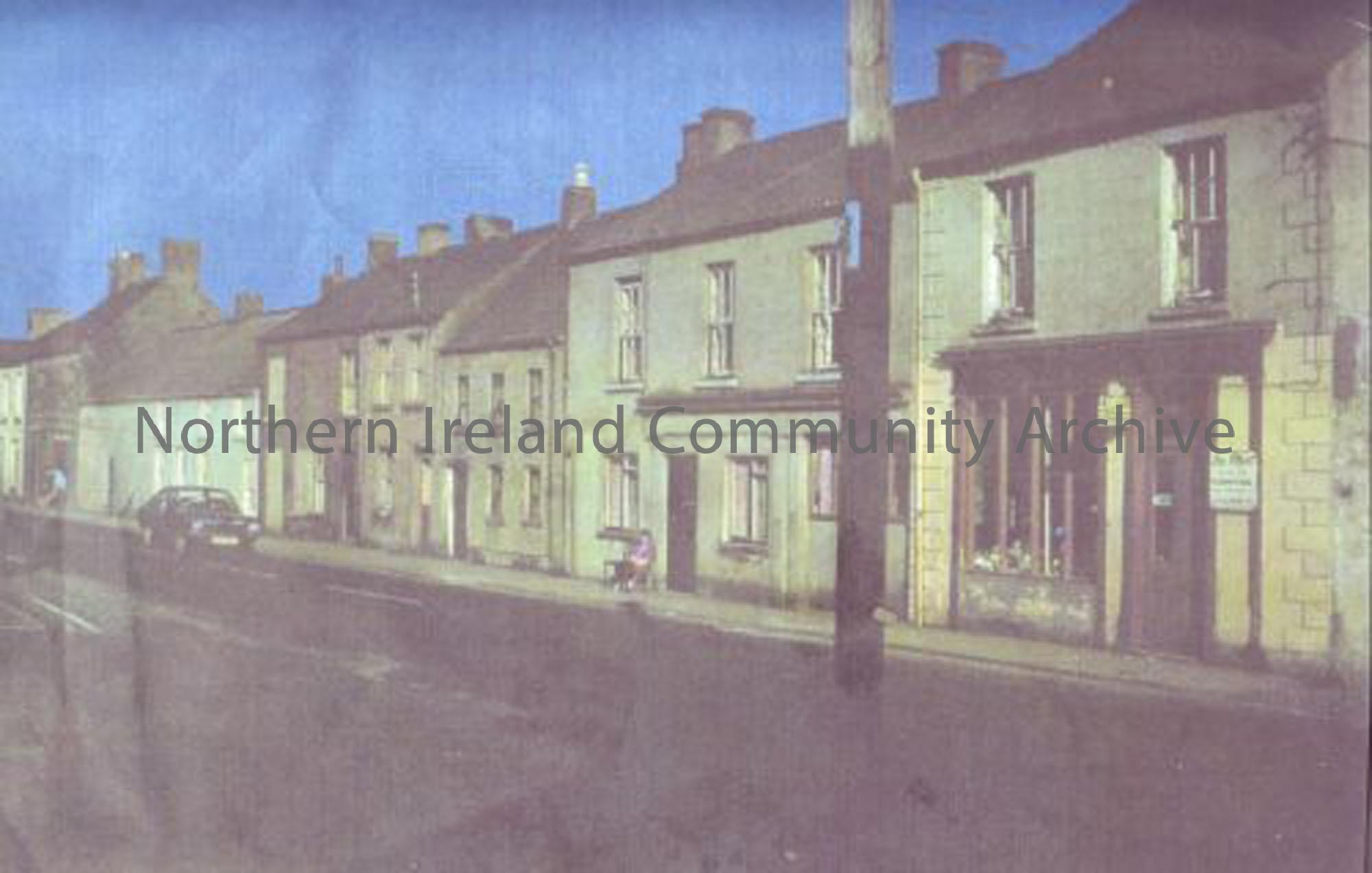 Castle Street, Ballymoney, 1970s, showing Mrs McConville sitting outside her front door. (1904)