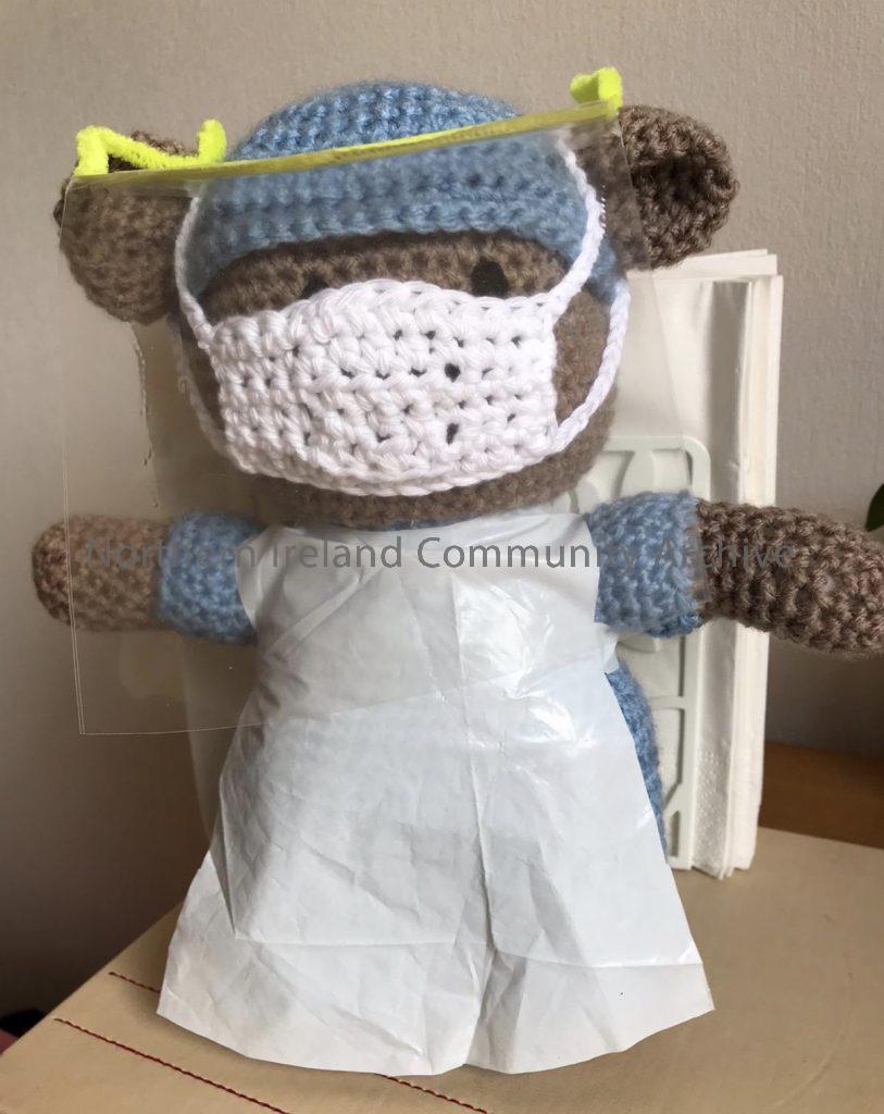 Crocheted bear depicting a nurse wearing Personal Protective Equipment (PPE) on the front line