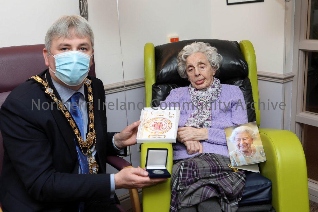 Centenary coin presented to Katie Bamford, resident of St James’ Lodge in Ballymoney