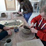 Accessible Heritage participants taking part in pottery workshops.