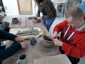 Accessible Heritage participants taking part in pottery workshops.