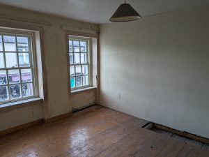 Photo of an empty room showing period windows.